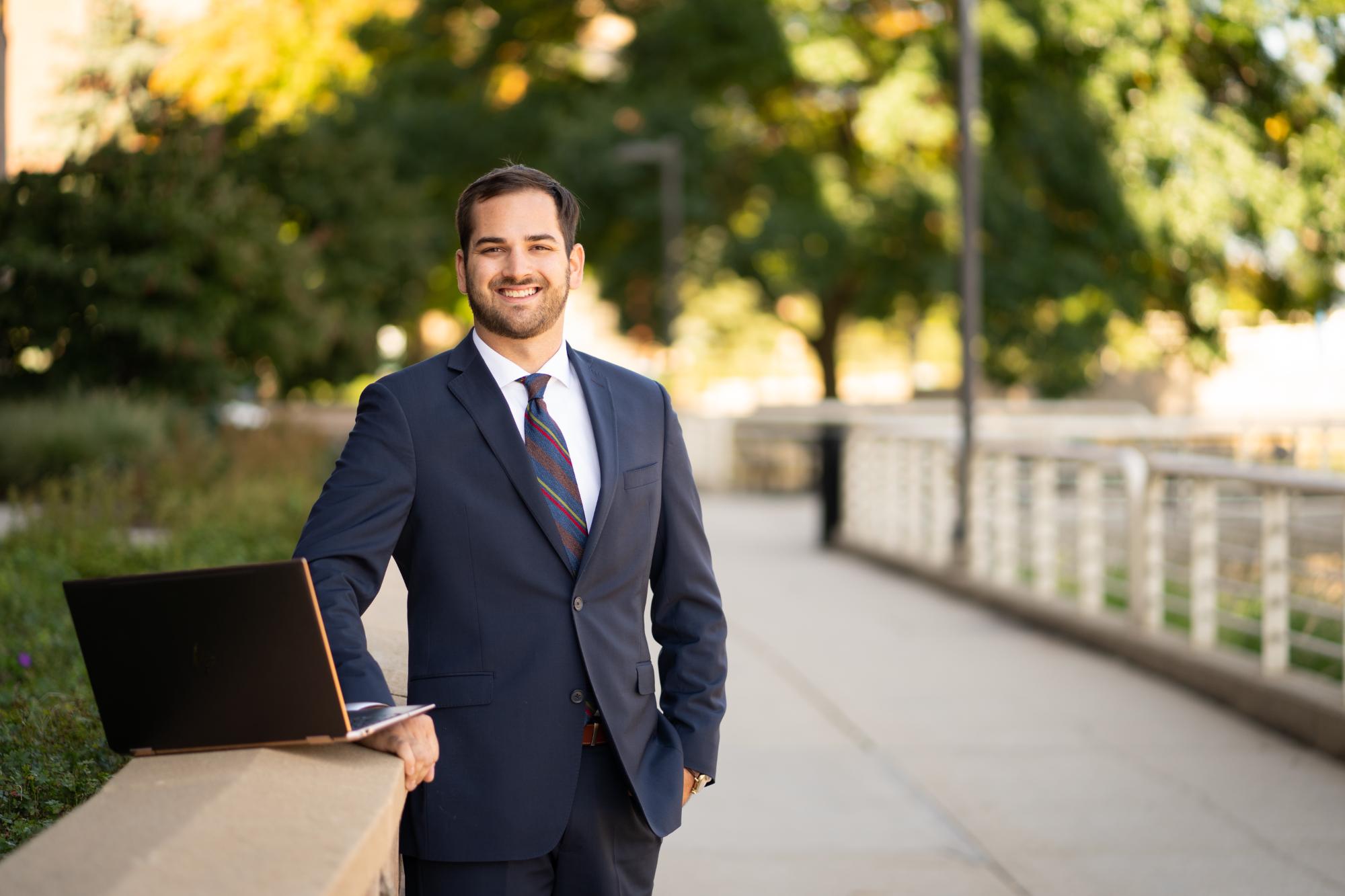 Man sitting at park with laptop
